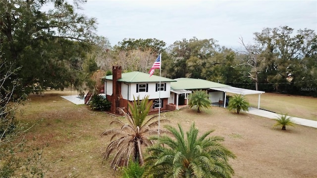 view of front of house with a carport and a front lawn