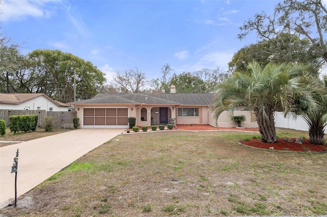 single story home featuring a garage and a front lawn