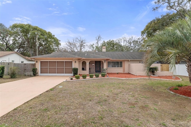 single story home featuring a garage and a front lawn