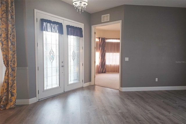 foyer entrance featuring hardwood / wood-style flooring, a wealth of natural light, and french doors