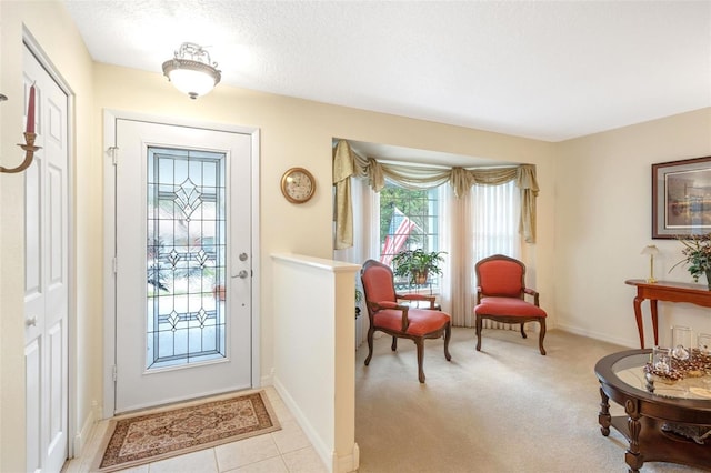 entrance foyer with light carpet