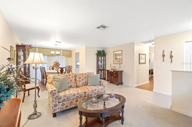 living room with an inviting chandelier and light tile patterned floors