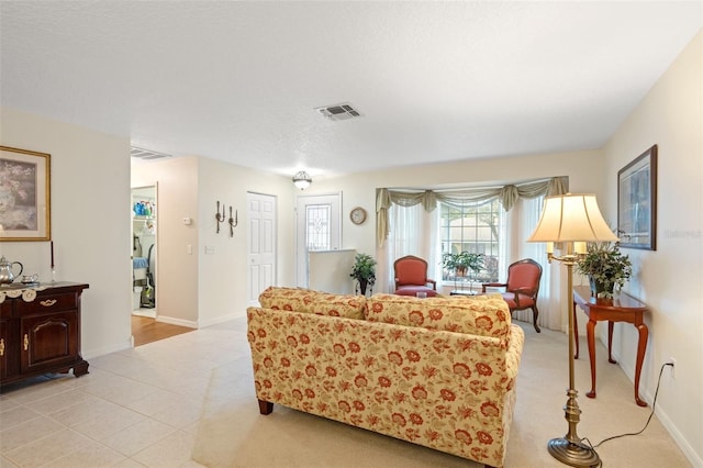 tiled living room with a textured ceiling