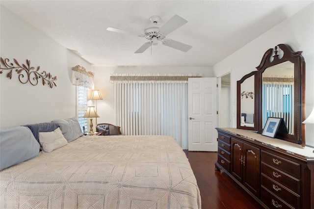 bedroom with dark hardwood / wood-style flooring, a textured ceiling, and ceiling fan