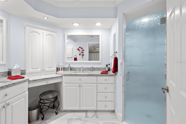 bathroom with a shower with door, vanity, and ornamental molding