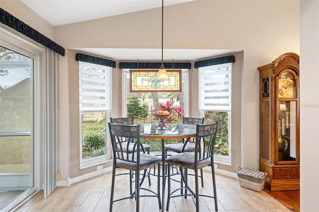 dining space featuring a healthy amount of sunlight and vaulted ceiling