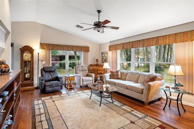 living room featuring lofted ceiling, a textured ceiling, ceiling fan, and dark hardwood / wood-style floors