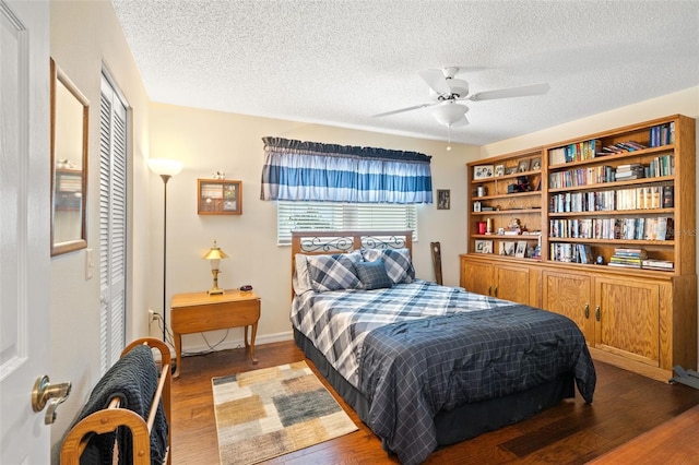 bedroom with ceiling fan, dark hardwood / wood-style flooring, a closet, and a textured ceiling