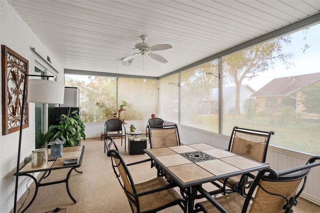 sunroom / solarium featuring ceiling fan