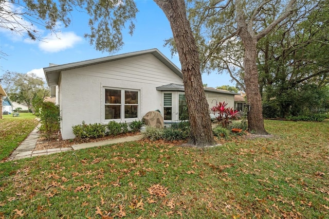 view of side of property with a yard