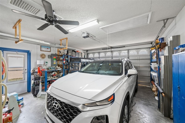 garage featuring electric panel, a garage door opener, and ceiling fan