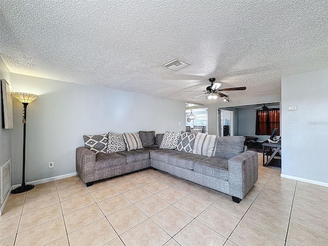 living room featuring ceiling fan and light tile patterned floors