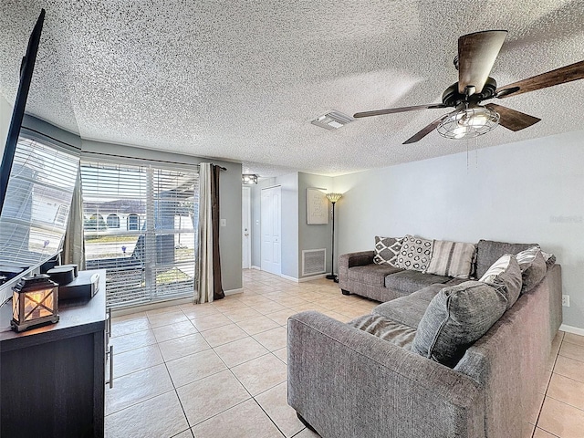 tiled living room featuring ceiling fan