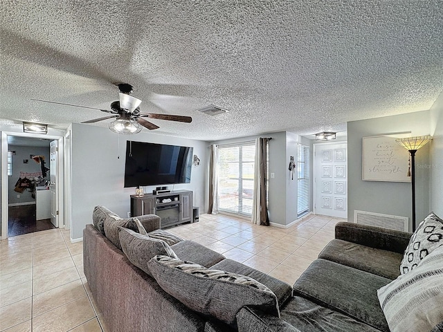 living room featuring ceiling fan and light tile patterned flooring