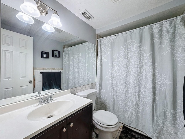 bathroom featuring toilet, vanity, tile walls, and a textured ceiling