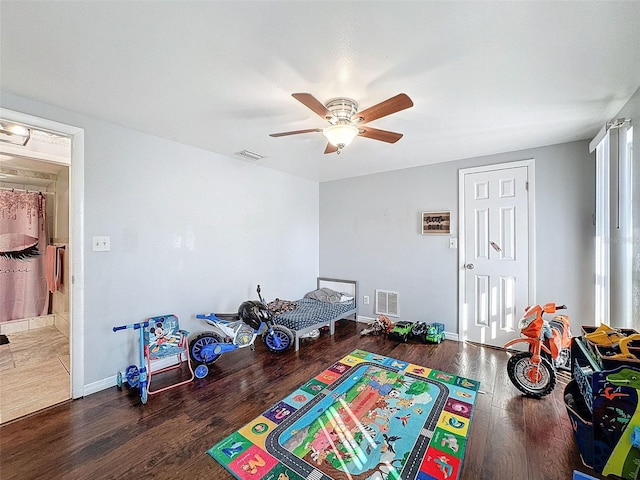 game room with ceiling fan and dark wood-type flooring