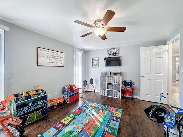 playroom featuring ceiling fan and dark hardwood / wood-style floors