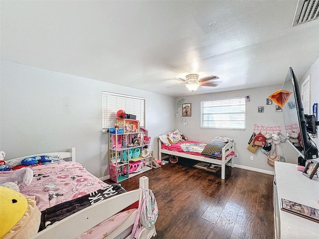 bedroom with ceiling fan and dark hardwood / wood-style flooring