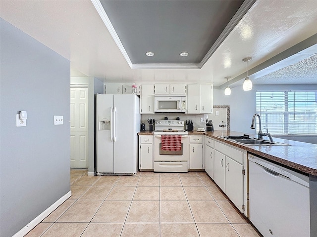 kitchen featuring sink, a tray ceiling, white appliances, white cabinetry, and light tile patterned flooring