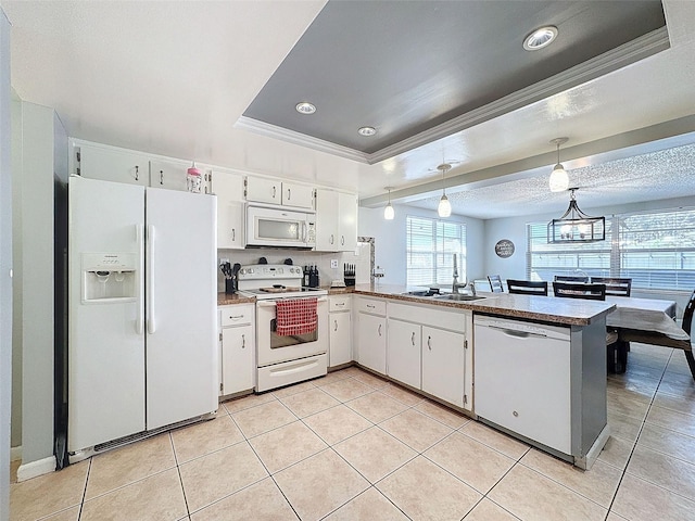 kitchen featuring kitchen peninsula, sink, white appliances, hanging light fixtures, and white cabinets