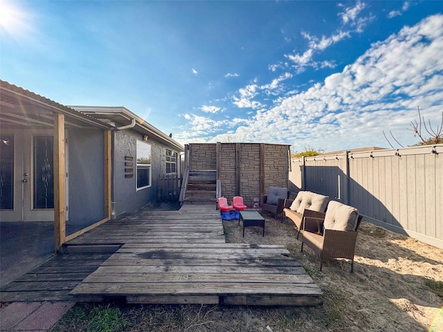 wooden terrace with an outdoor living space