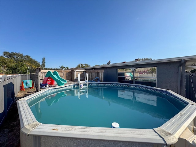 view of swimming pool featuring a playground