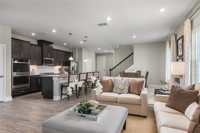 3744 Sky Mountain Aly, Apopka, FL 32712 - living room with light hardwood / wood-style flooring and a fireplace