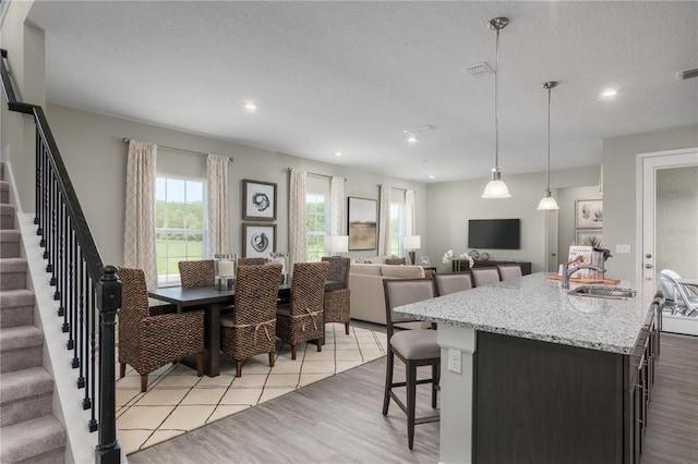 3744 Sky Mountain Aly, Apopka, FL 32712 - dining room featuring sink, a textured ceiling, and light wood-type flooring
