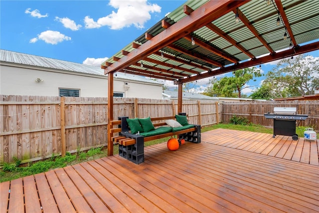 wooden deck with grilling area and a pergola