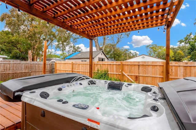 deck featuring a pergola and a hot tub