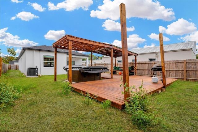 wooden terrace with central AC unit, a lawn, and a hot tub