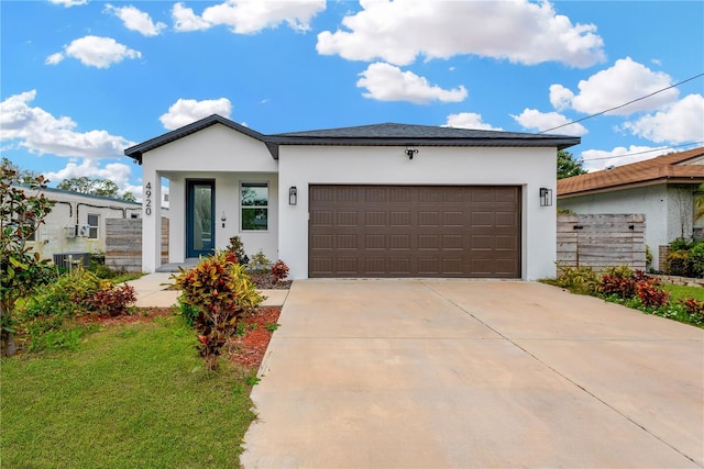 view of front of home with a front lawn and a garage