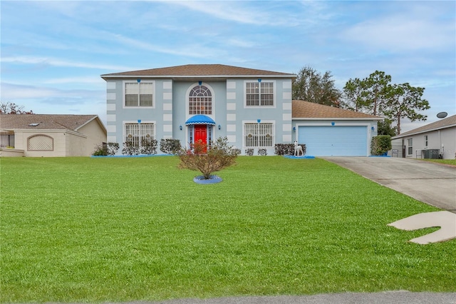 view of front of home with a front lawn and a garage