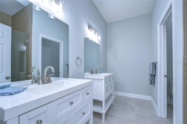 bathroom with toilet, vanity, and walk in shower