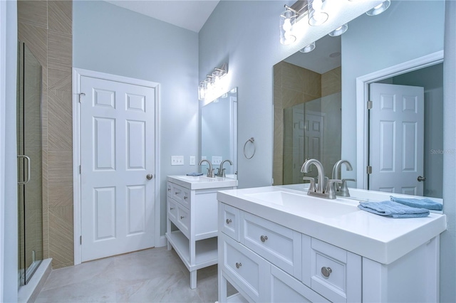 bathroom featuring a shower with shower door, vanity, and tile patterned flooring