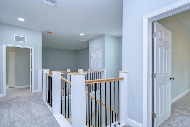 corridor with light colored carpet