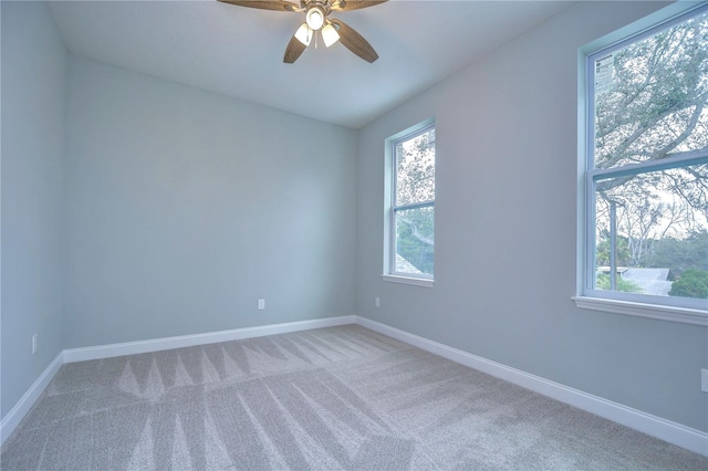 unfurnished room featuring ceiling fan and carpet flooring