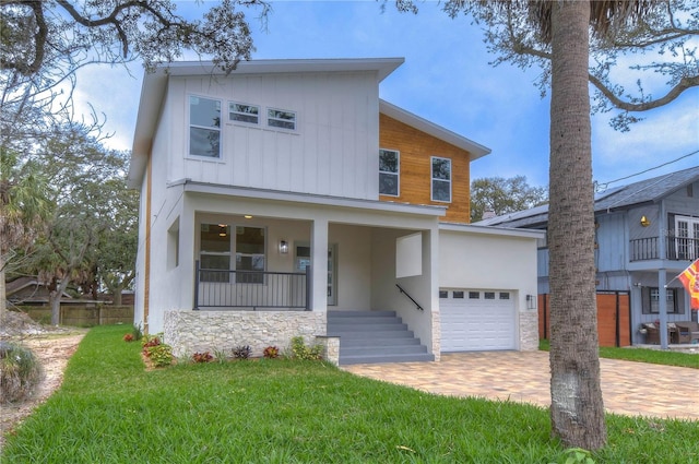 view of front of house with a garage and a front yard