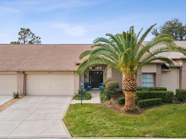 view of front of property with a garage and a front yard