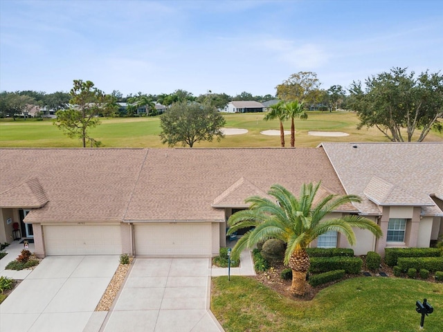 ranch-style house featuring a front yard and a garage