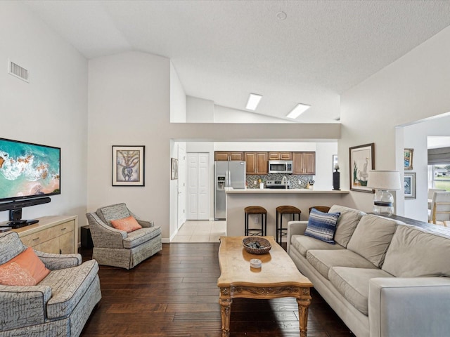 living room featuring hardwood / wood-style floors and lofted ceiling