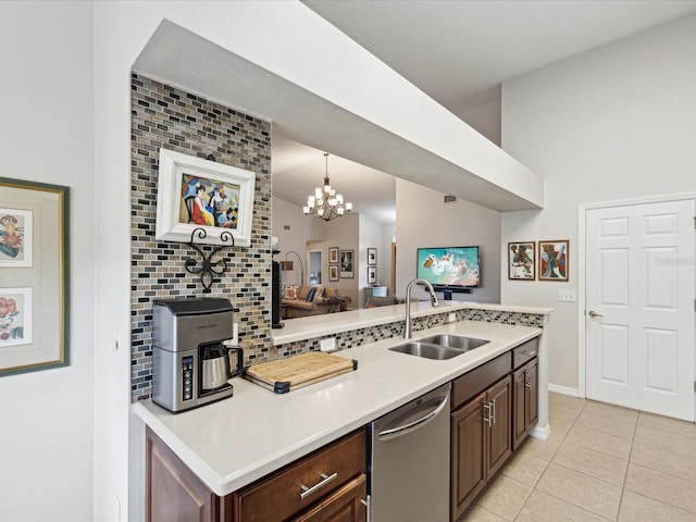 kitchen featuring light tile patterned floors, sink, dark brown cabinetry, and stainless steel dishwasher