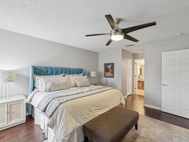 bedroom with ceiling fan, a textured ceiling, ensuite bathroom, and dark hardwood / wood-style floors