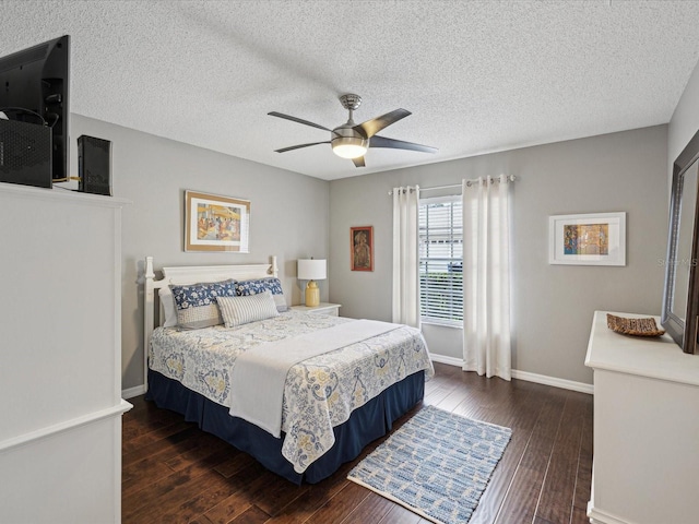 bedroom with dark wood-type flooring, a textured ceiling, and ceiling fan