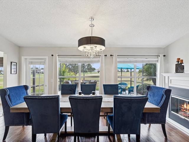 dining area with an inviting chandelier, dark hardwood / wood-style floors, and plenty of natural light