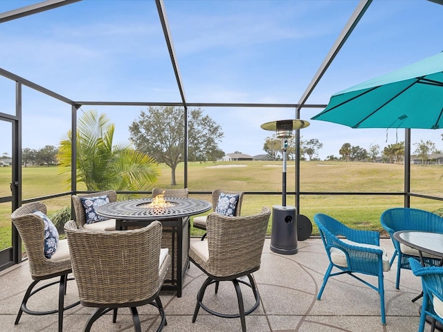 view of patio / terrace with a lanai and an outdoor fire pit