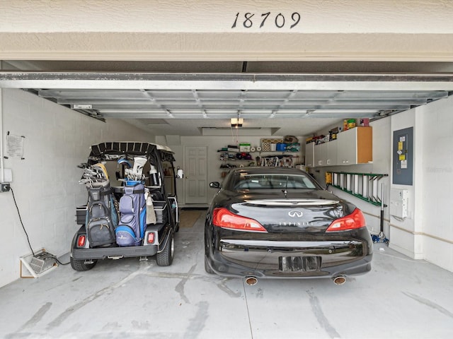 garage with electric panel and a garage door opener