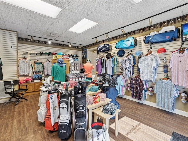 miscellaneous room featuring hardwood / wood-style flooring and a drop ceiling