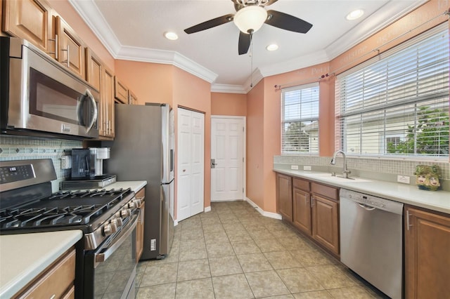 kitchen featuring decorative backsplash, sink, appliances with stainless steel finishes, and ceiling fan