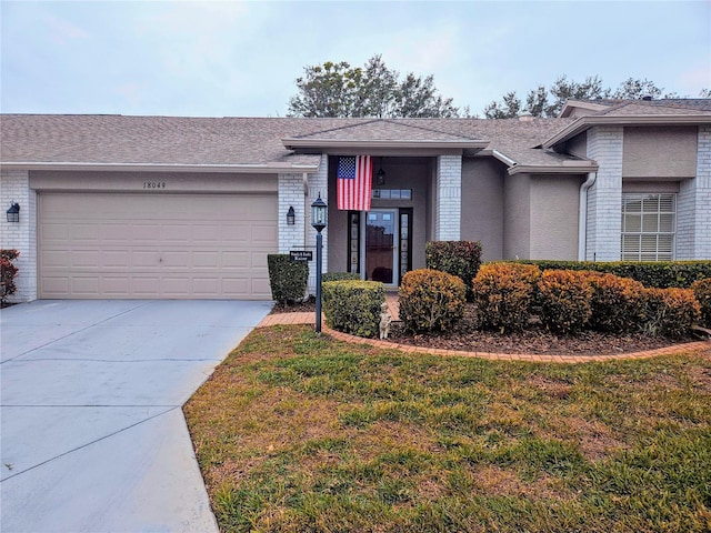 view of front facade featuring a front lawn and a garage